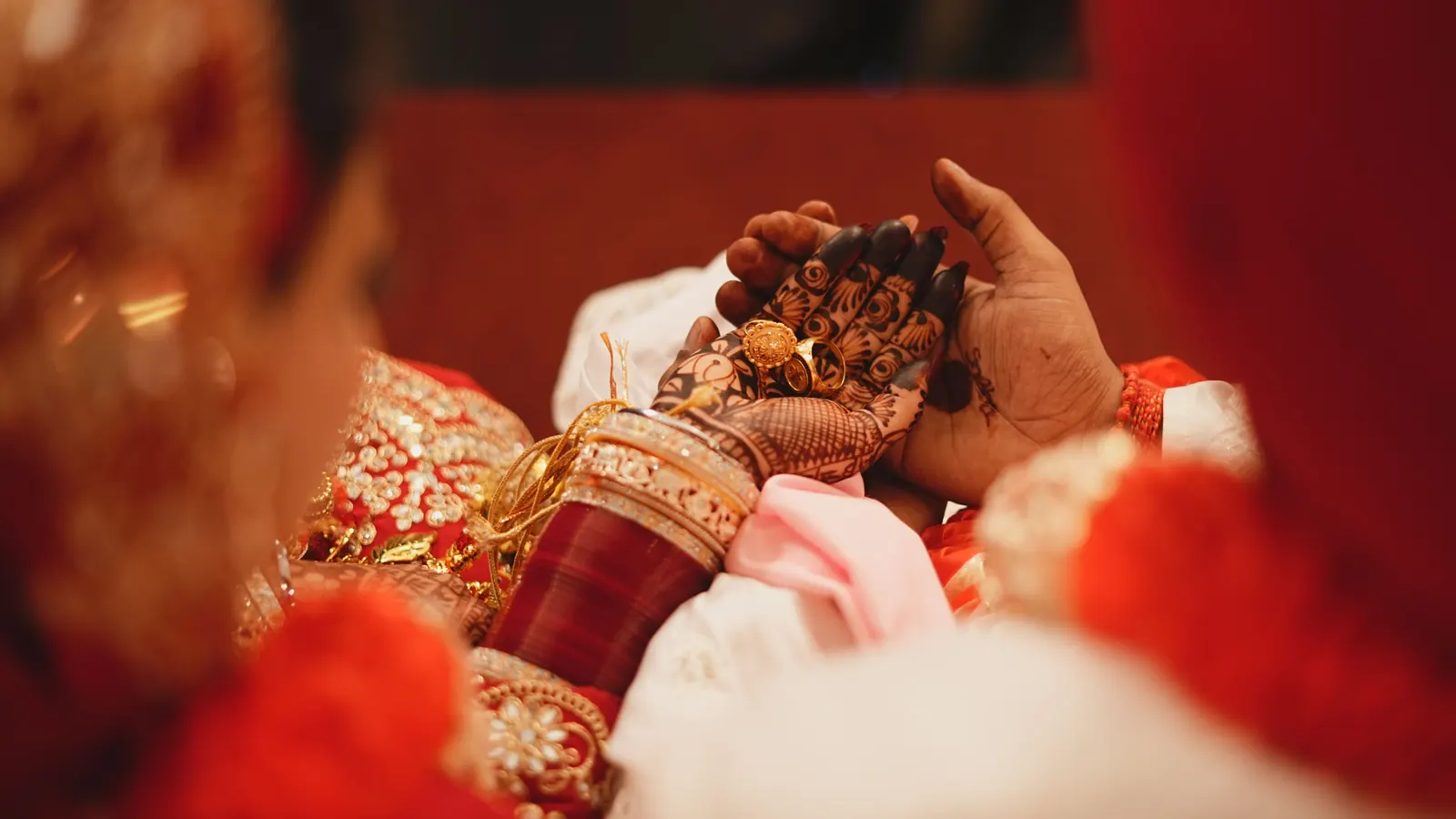 Close-up of a wedding ritual with gold ornaments