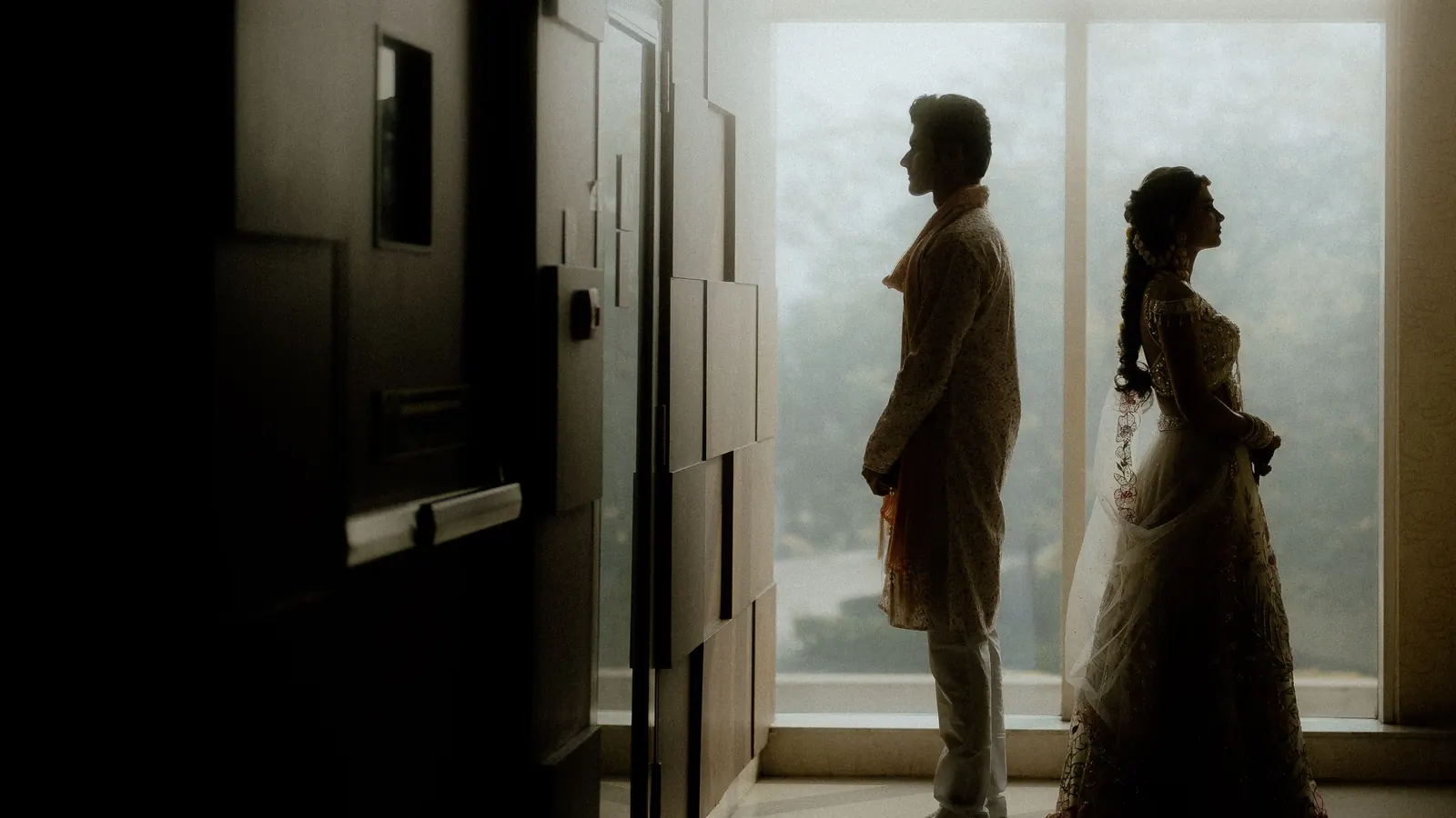 A couple seen in silhouette through a doorway