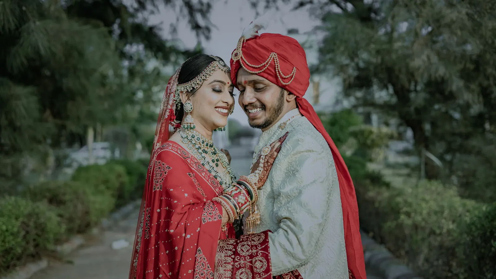 A couple at an Indian wedding, photographed in a garden