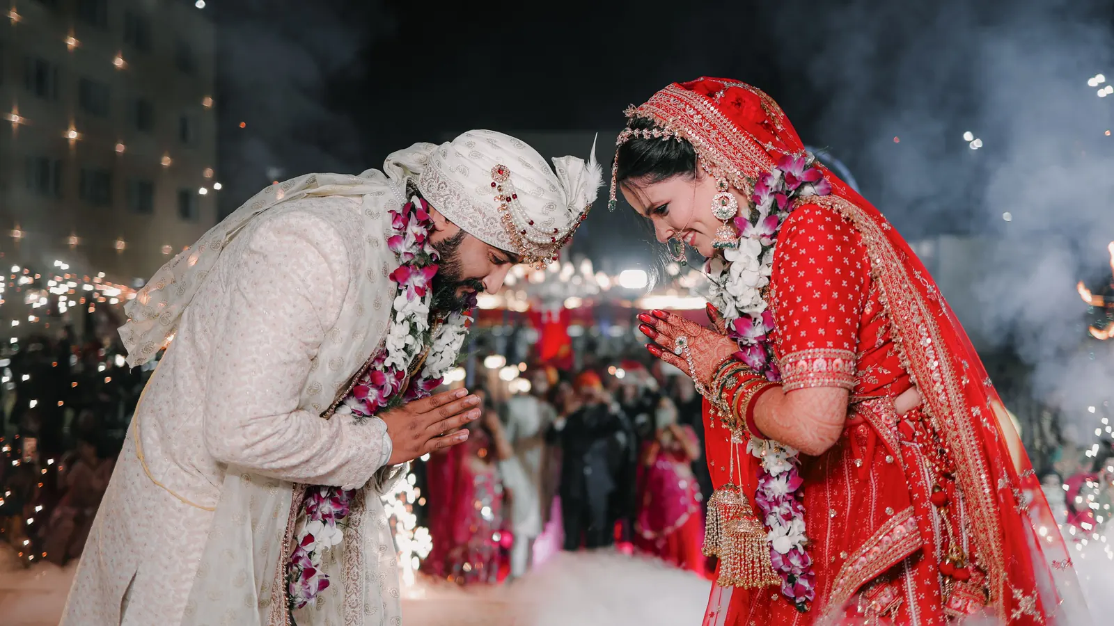 A couple celebrating with sparklers at a wedding
